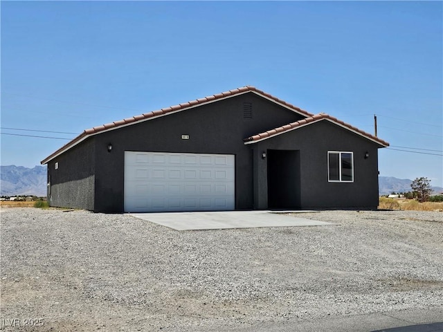 1870 Upland Ave, Pahrump, NV 89048 - single story home with a tile roof, a garage, a mountain view, and stucco siding
