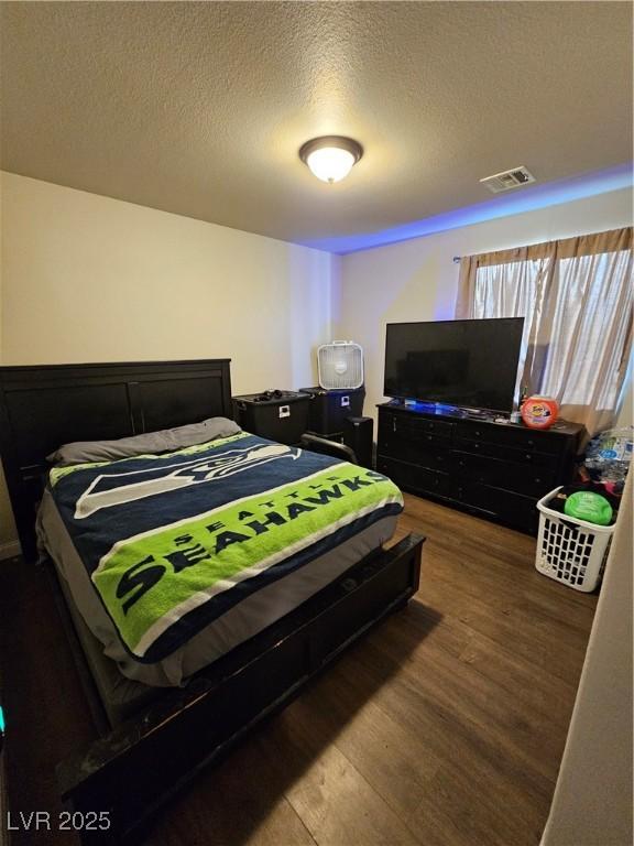 1870 Upland Ave, Pahrump, NV 89048 - bedroom featuring wood finished floors and a textured ceiling