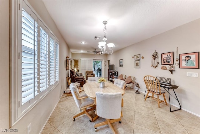 2522 Darda St, Henderson, NV 89044 - dining area with healthy amount of natural light, a chandelier, baseboards, and light tile patterned floors