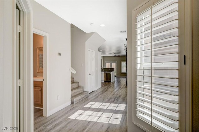 5931 Allanche Ave, Las Vegas, NV 89141 - corridor with light wood-style floors and stairs