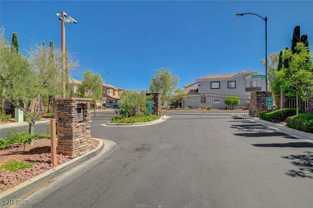 5931 Allanche Ave, Las Vegas, NV 89141 - view of asphalt street featuring a residential view, street lighting, and a gate