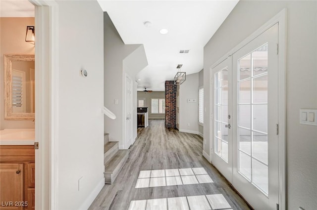 5931 Allanche Ave, Las Vegas, NV 89141 - corridor with french doors, stairs, and light wood finished floors