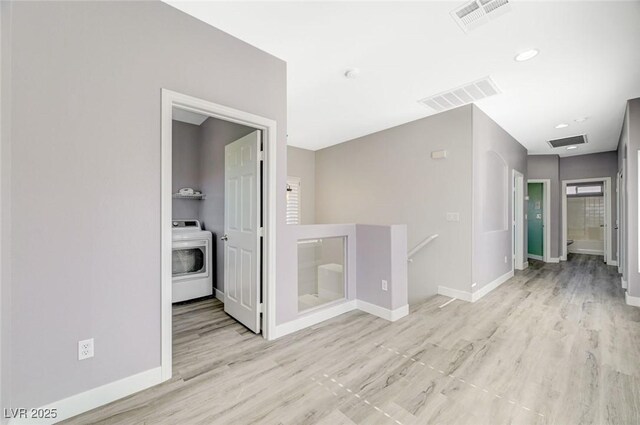5931 Allanche Ave, Las Vegas, NV 89141 - hall featuring washer / clothes dryer, an upstairs landing, and wood finished floors