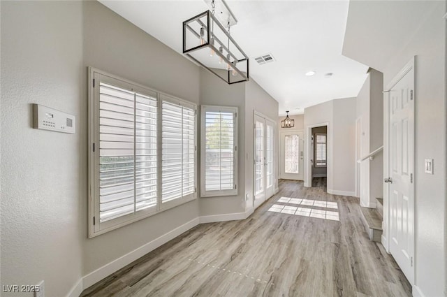 5931 Allanche Ave, Las Vegas, NV 89141 - unfurnished dining area featuring wood finished floors and a chandelier