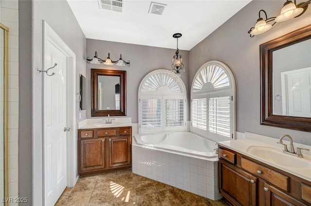 5931 Allanche Ave, Las Vegas, NV 89141 - full bathroom with a garden tub, two vanities, a tile shower, and tile patterned floors