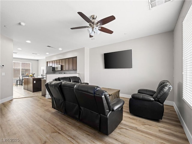 4563 Townwall St, Las Vegas, NV 89115 - living area with light wood-type flooring, a ceiling fan, baseboards, and recessed lighting
