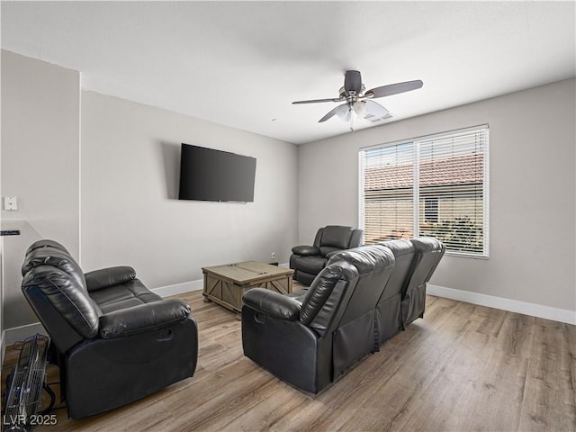 4563 Townwall St, Las Vegas, NV 89115 - living room with light wood finished floors, a ceiling fan, and baseboards