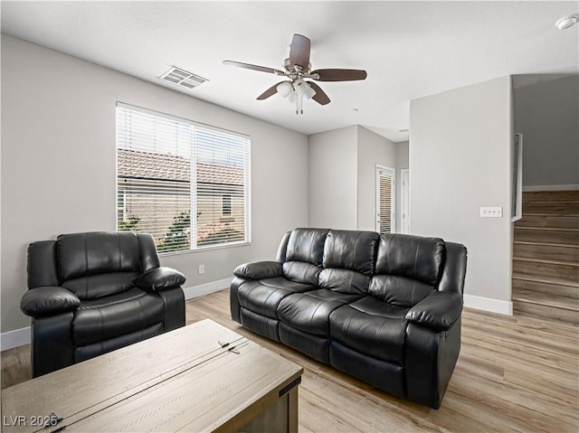 4563 Townwall St, Las Vegas, NV 89115 - living room with baseboards, a ceiling fan, and light wood-style floors