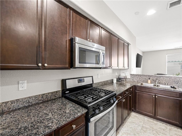 4563 Townwall St, Las Vegas, NV 89115 - kitchen featuring appliances with stainless steel finishes, a sink, and dark brown cabinets