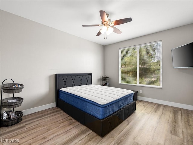 4563 Townwall St, Las Vegas, NV 89115 - bedroom with wood finished floors, baseboards, and ceiling fan