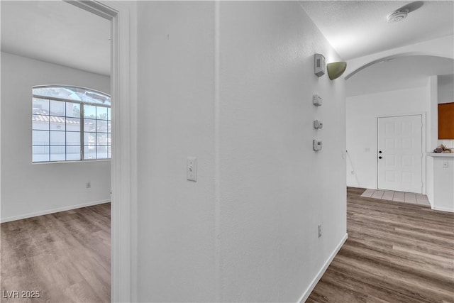 1300 S Arlington St Unit 120, Las Vegas, NV 89104 - corridor featuring wood finished floors, arched walkways, and baseboards