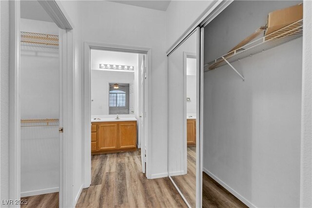 1300 S Arlington St Unit 120, Las Vegas, NV 89104 - hall featuring light wood finished floors, baseboards, and a sink