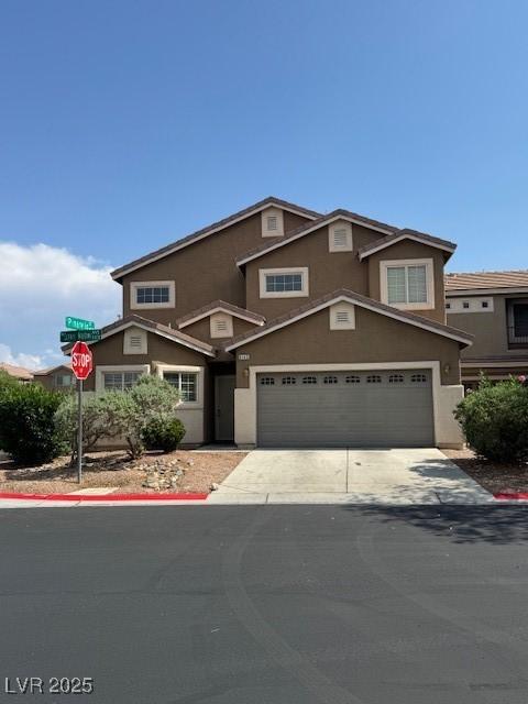 9145 Sunken Meadow Ave, Las Vegas, NV 89178 - view of front of home with stucco siding, driveway, and an attached garage