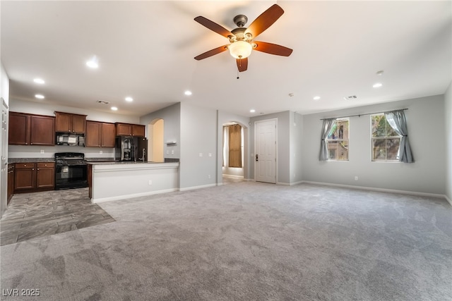 10917 Mount Pendleton St, Las Vegas, NV 89179 - unfurnished living room featuring arched walkways, light colored carpet, recessed lighting, a ceiling fan, and baseboards