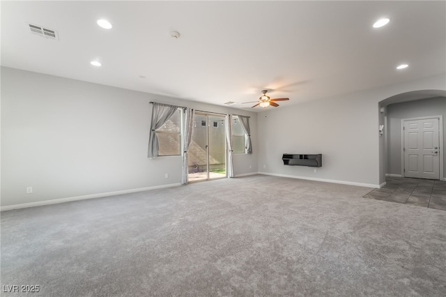 10917 Mount Pendleton St, Las Vegas, NV 89179 - unfurnished living room with arched walkways, carpet, ceiling fan, baseboards, and recessed lighting