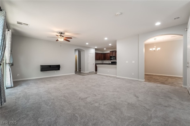 10917 Mount Pendleton St, Las Vegas, NV 89179 - unfurnished living room with arched walkways, recessed lighting, a ceiling fan, light carpet, and baseboards