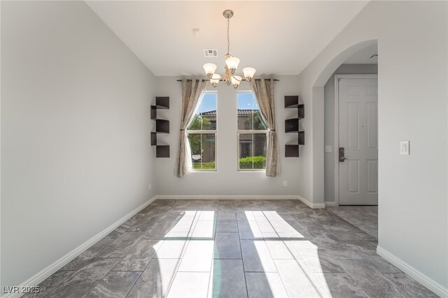 10917 Mount Pendleton St, Las Vegas, NV 89179 - unfurnished dining area with a chandelier, baseboards, arched walkways, and marble finish flooring