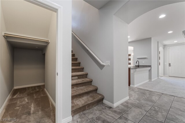 10917 Mount Pendleton St, Las Vegas, NV 89179 - staircase featuring recessed lighting, carpet floors, baseboards, and arched walkways