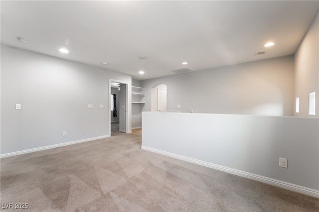 10917 Mount Pendleton St, Las Vegas, NV 89179 - spare room featuring arched walkways, recessed lighting, light colored carpet, baseboards, and a smoke detector