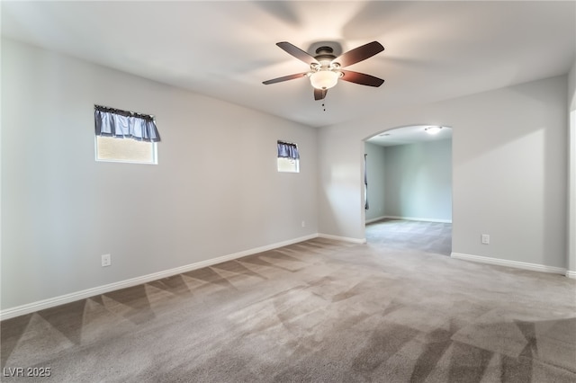 10917 Mount Pendleton St, Las Vegas, NV 89179 - empty room featuring arched walkways, ceiling fan, carpet flooring, and healthy amount of natural light
