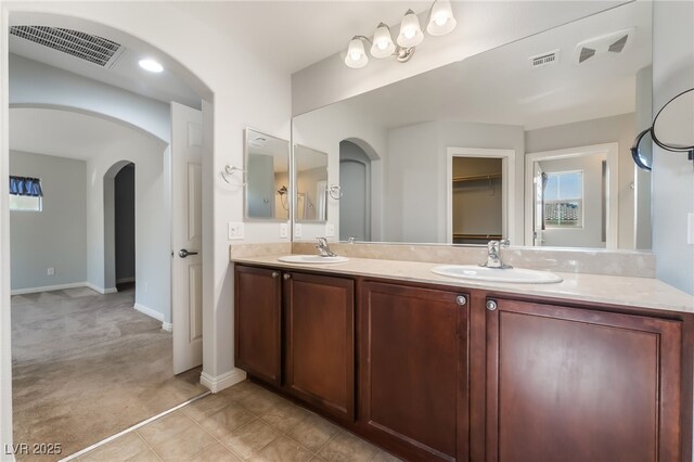 10917 Mount Pendleton St, Las Vegas, NV 89179 - full bath with double vanity, baseboards, and plenty of natural light