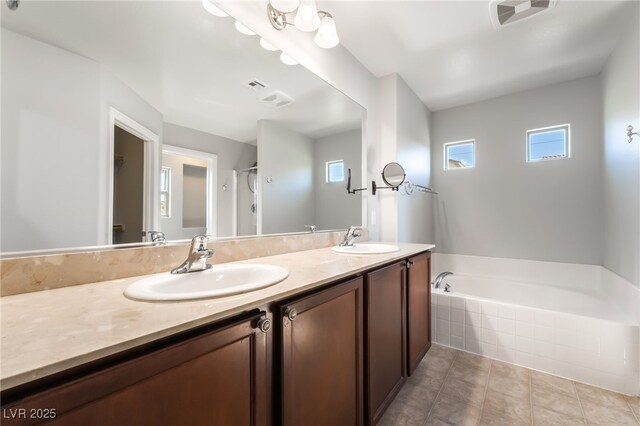10917 Mount Pendleton St, Las Vegas, NV 89179 - bathroom with double vanity, a bath, and tile patterned flooring