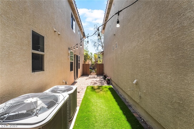 10917 Mount Pendleton St, Las Vegas, NV 89179 - view of side of home featuring central AC and stucco siding