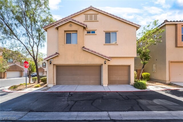 10917 Mount Pendleton St, Las Vegas, NV 89179 - multi unit property with an attached garage, a tiled roof, stucco siding, and driveway