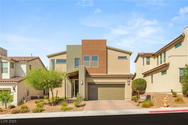 6901 Whisper Canyon Pl, North Las Vegas, NV 89084 - view of front of property featuring an attached garage, decorative driveway, and stucco siding