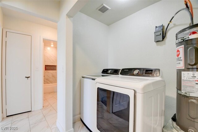 1123 Chapman Dr, Las Vegas, NV 89104 - laundry area with washer and dryer, light marble finish floors, and water heater