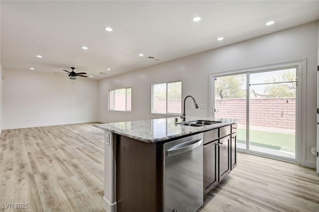7372 S Palo Real Ct, Las Vegas, NV 89179 - kitchen with dishwasher, recessed lighting, light wood-style flooring, light stone countertops, and a center island with sink