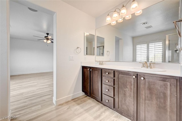 7372 S Palo Real Ct, Las Vegas, NV 89179 - full bath with wood finished floors, a ceiling fan, and double vanity