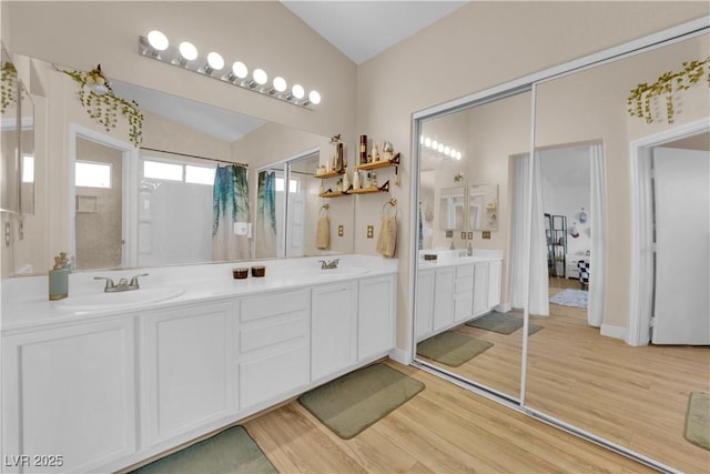 6108 Shallow Springs St, Las Vegas, NV 89130 - full bathroom featuring lofted ceiling, double vanity, and wood finished floors