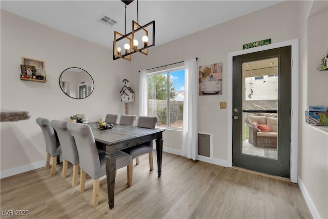 6108 Shallow Springs St, Las Vegas, NV 89130 - dining room with a chandelier, light wood-style floors, and baseboards