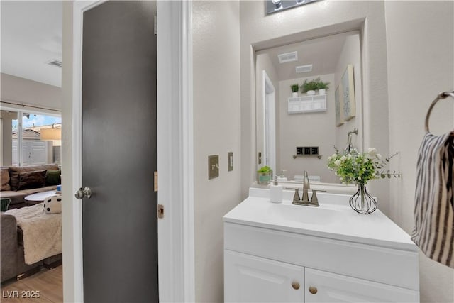 6108 Shallow Springs St, Las Vegas, NV 89130 - ensuite bathroom with vanity and wood finished floors