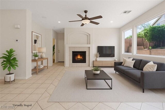 10680 Sapphire Vista Ave, Las Vegas, NV 89144 - living room with a ceiling fan, a tiled fireplace, recessed lighting, light tile patterned floors, and baseboards