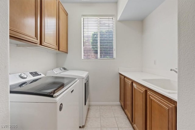 10680 Sapphire Vista Ave, Las Vegas, NV 89144 - laundry area with washer and dryer, cabinet space, baseboards, and light tile patterned floors
