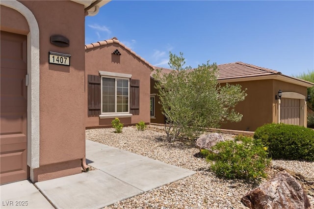 1407 Wheelwright Ct, Mesquite, NV 89034 - doorway to property featuring a tile roof and stucco siding
