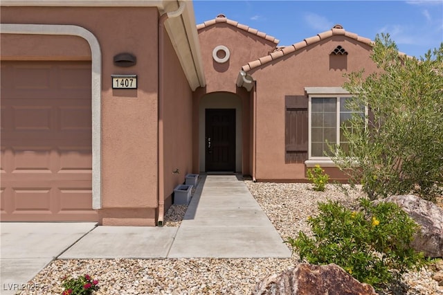 1407 Wheelwright Ct, Mesquite, NV 89034 - entrance to property with an attached garage and stucco siding