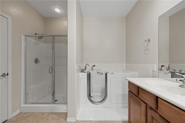 1407 Wheelwright Ct, Mesquite, NV 89034 - full bath featuring a shower stall, a bath, vanity, tile patterned flooring, and baseboards