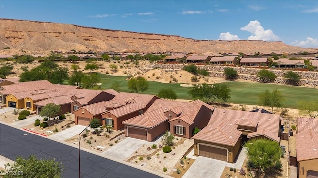 1407 Wheelwright Ct, Mesquite, NV 89034 - aerial perspective of suburban area featuring a mountain backdrop and a local golf course