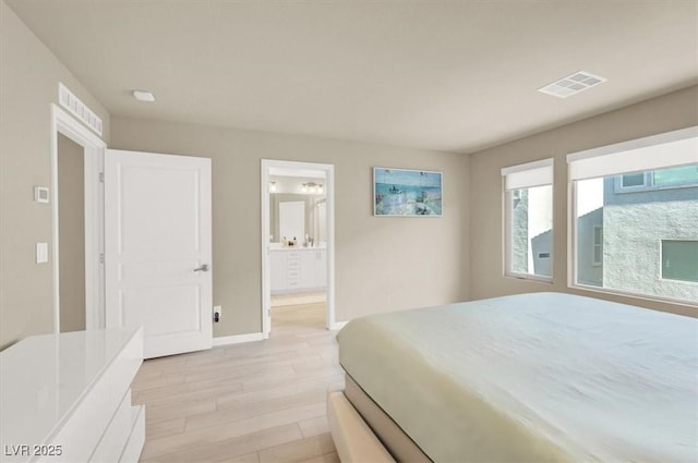 8060 Haywood Estate Ave, Las Vegas, NV 89113 - bedroom with light wood finished floors, baseboards, and ensuite bathroom