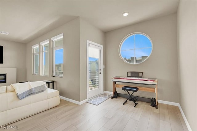 8060 Haywood Estate Ave, Las Vegas, NV 89113 - office area with baseboards, wood finished floors, a glass covered fireplace, and recessed lighting