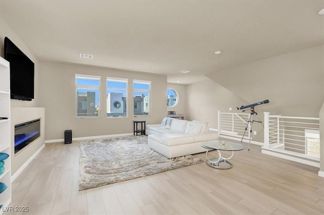 8060 Haywood Estate Ave, Las Vegas, NV 89113 - living room featuring light wood-type flooring, baseboards, and a glass covered fireplace