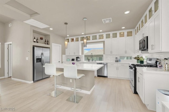 8060 Haywood Estate Ave, Las Vegas, NV 89113 - kitchen with stainless steel appliances, a sink, decorative backsplash, light countertops, and recessed lighting