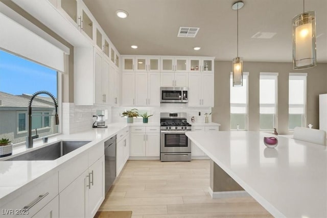8060 Haywood Estate Ave, Las Vegas, NV 89113 - kitchen with appliances with stainless steel finishes, healthy amount of natural light, a sink, tasteful backsplash, and recessed lighting