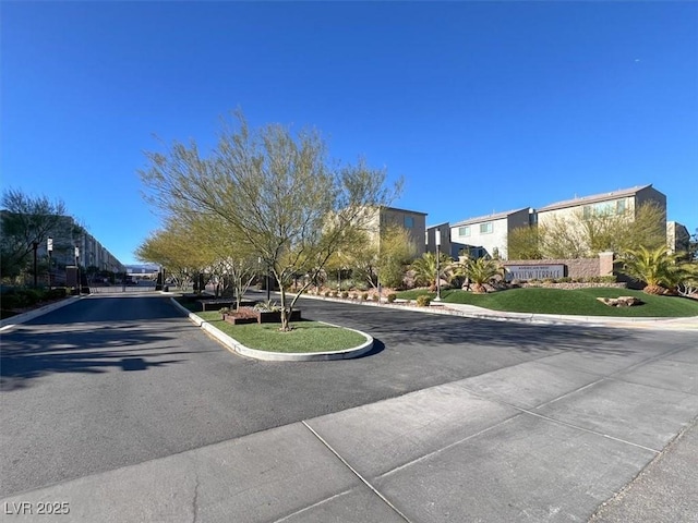 8060 Haywood Estate Ave, Las Vegas, NV 89113 - view of asphalt road featuring curbs and street lights