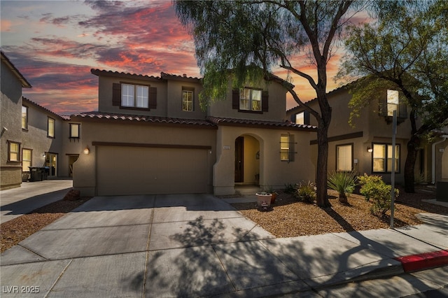 632 Monument Point St, Henderson, NV 89002 - mediterranean / spanish home with stucco siding, driveway, a tiled roof, and an attached garage