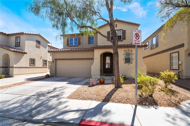 632 Monument Point St, Henderson, NV 89002 - mediterranean / spanish home featuring stucco siding, concrete driveway, a garage, and a tiled roof