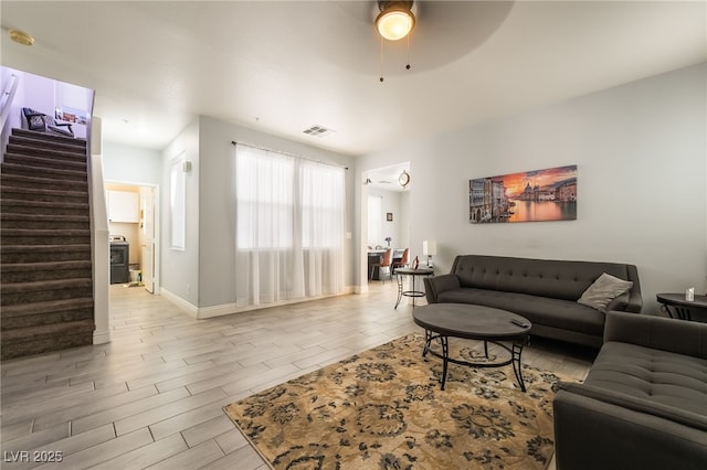 632 Monument Point St, Henderson, NV 89002 - living room with stairs, wood finished floors, a ceiling fan, and baseboards